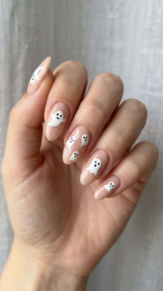 Spooky ghost nails with cute white ghost designs on a clean base, creating a playful, minimal, and stylish Halloween manicure look