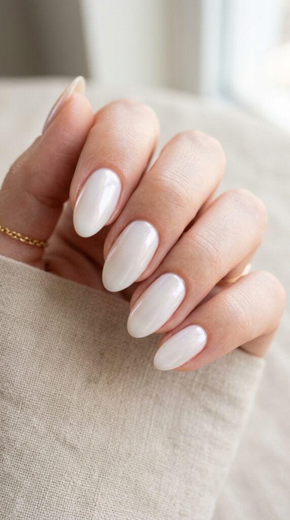 Glazed milk nails with a soft milky white glossy finish, creating a clean, minimal, and trendy manicure look