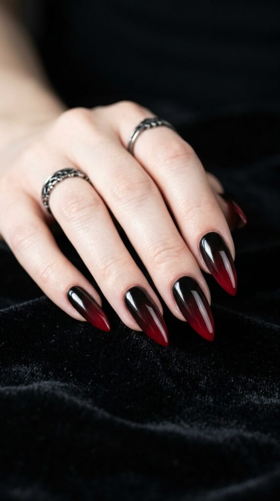 Black to deep red gothic ombre nails with a dramatic gradient blend, creating a bold, edgy, and dark aesthetic manicure look