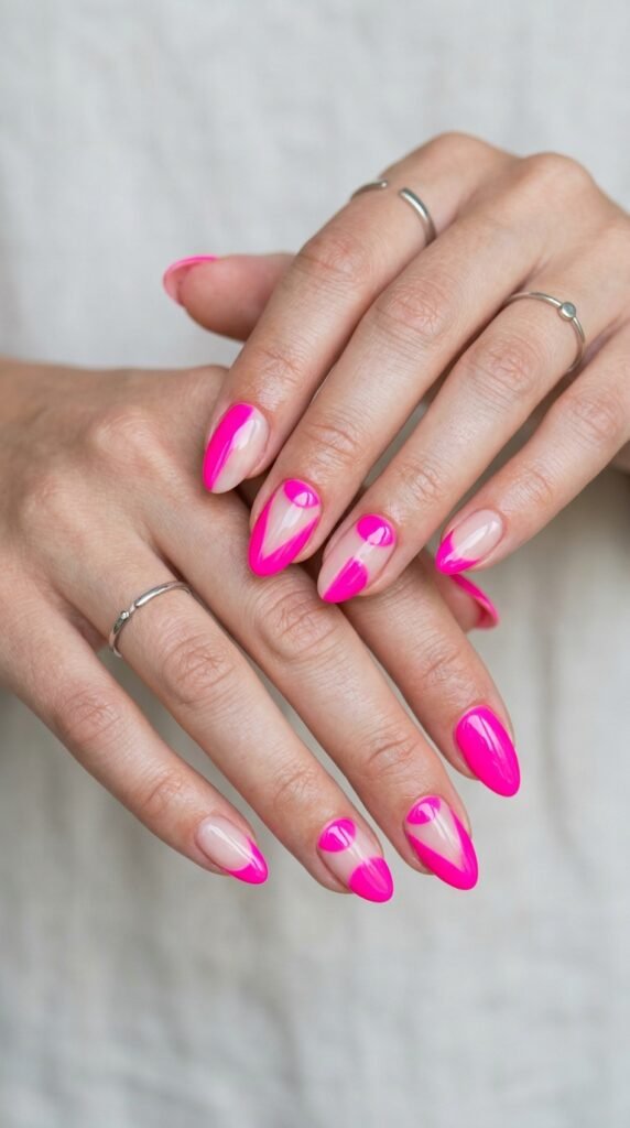 Hands with hot pink neon nail polish featuring clean white negative space areas creating geometric patterns for modern minimalist bold summer manicure design.