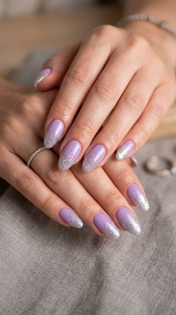 Lavender to silver glitter fade ombre nails with romantic purple base transitioning to sparkling silver glitter tips for elegant summer evening nail art.