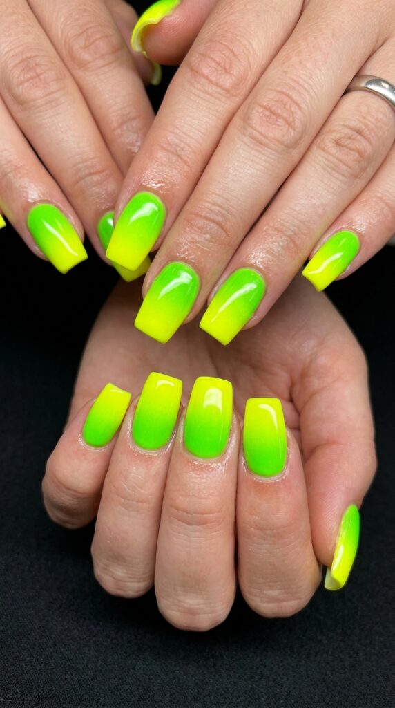 Lime green to yellow neon ombre gradient nails with electric transition from vibrant lime base to bright neon yellow tips for bold festival summer nail art.