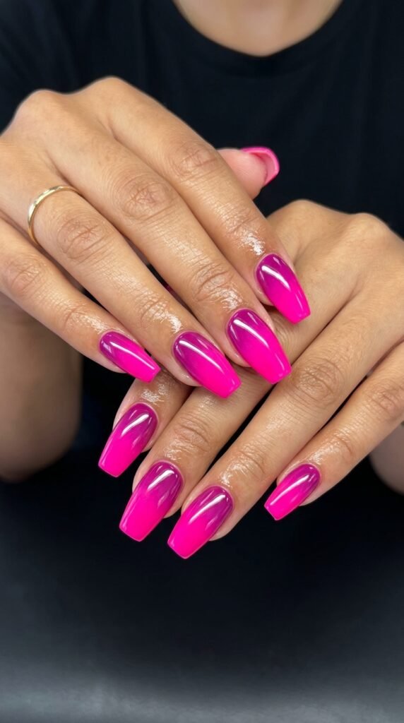 Magenta to hot pink power ombre gradient nails with bold transition from deep magenta base to electric hot pink tips for confident statement summer nail art.