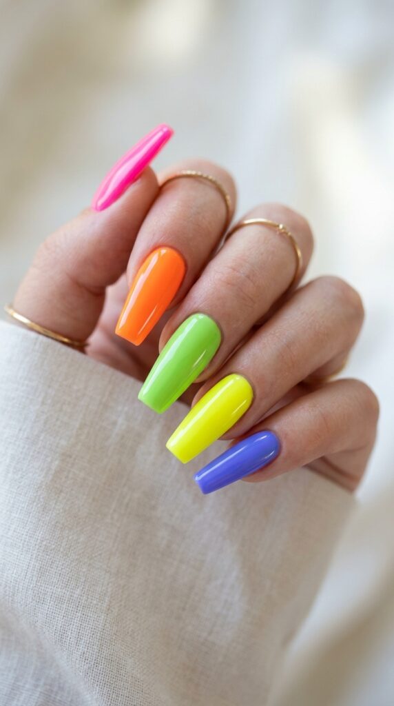 Bright neon coffin nails in bold vibrant colors with a glossy finish, creating a fun and eye-catching summer aesthetic