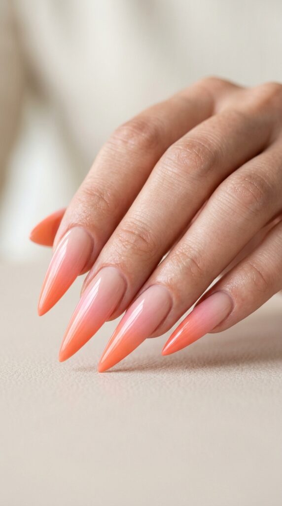 Ombre stiletto nails with a smooth gradient blend, glossy finish, and a soft elegant modern nail aesthetic