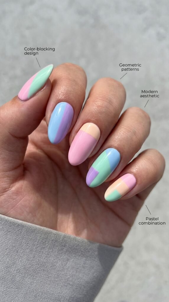 Modern pastel color-blocking nail designs featuring geometric divisions filled with complementary soft colors like pink-and-blue, lavender-and-mint, or peach-and-yellow blocks with clean edges, structured composition, and contemporary artistic aesthetic demonstrating professional precision and graphic sophistication.






