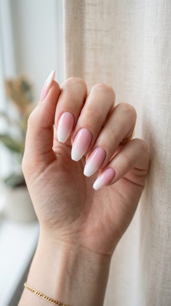 Classic pink to white ombre nails with a soft gradient blend and glossy finish, creating a timeless, elegant, and clean manicure look