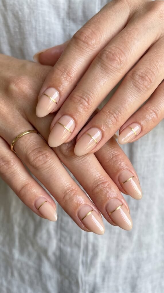 Hands with single thin accent line nail design featuring precise contrasting line on neutral base demonstrating minimalist elegance through restrained single element detail






