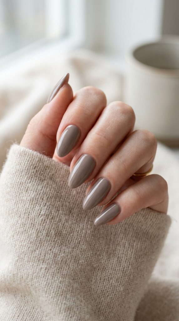 Quiet luxury taupe nails with a soft muted neutral tone and glossy finish, creating a minimalist, elegant, and sophisticated manicure look