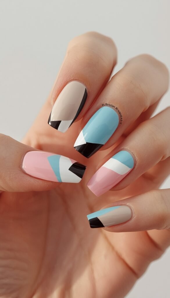 Geometric color blocking nails with bold shapes and contrasting colors, creating a modern, artistic, and eye-catching manicure design