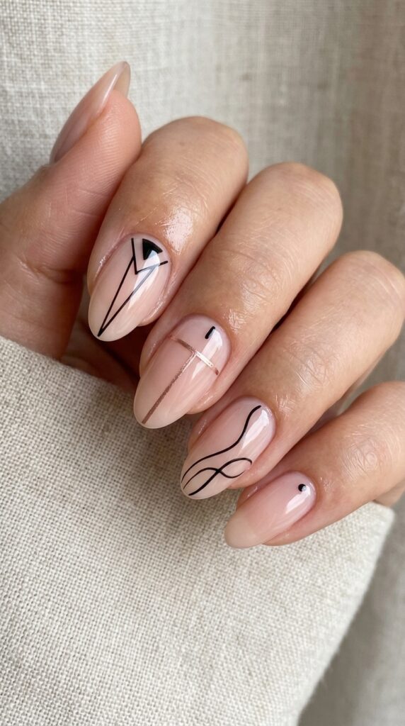 Minimal line art nails with thin delicate designs on a nude base, creating a clean, modern, and elegant manicure with a chic minimalist aesthetic