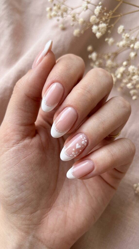 French tip nails with a romantic twist featuring hearts and soft accents, creating a feminine, elegant, and dreamy manicure look