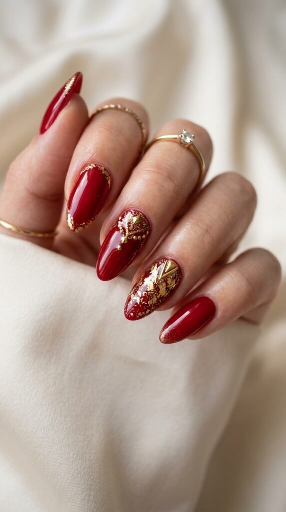 Classic red and gold glam nails with glossy finish and metallic accents, creating a bold, elegant, and luxurious manicure perfect for festive and special occasions